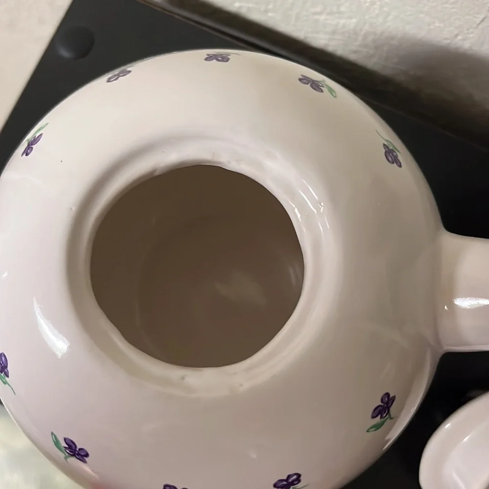 Small white teapot with violet and bee details.
